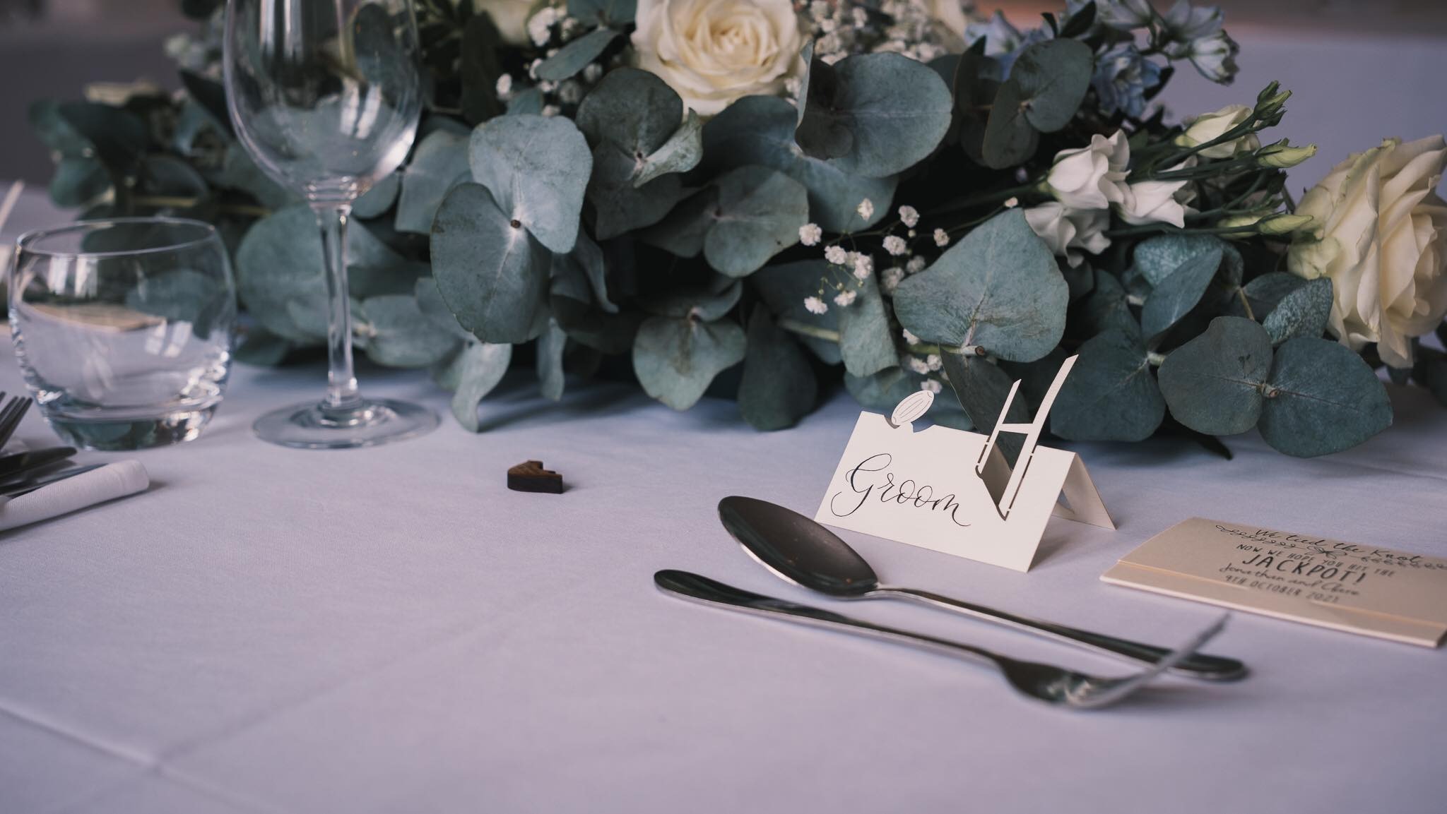Rugby style table setting for groom written in calligraphy