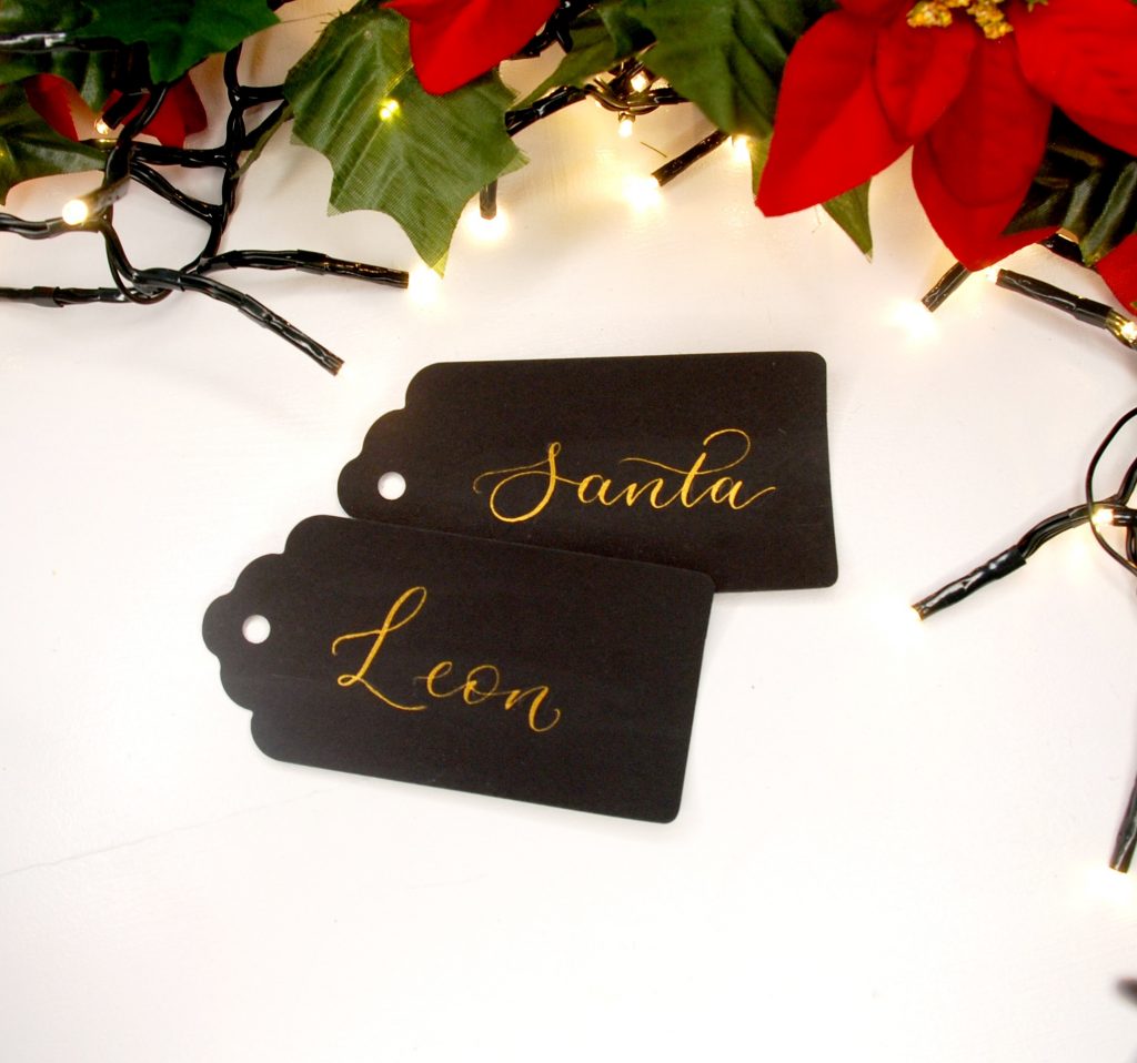 Personalised black gift tags in gold ink in modern calligraphy