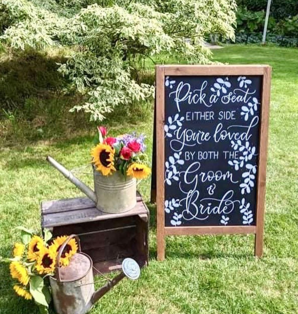 Image of wedding chalkboard that says pick a seat either side you are loved by both the groom and bride