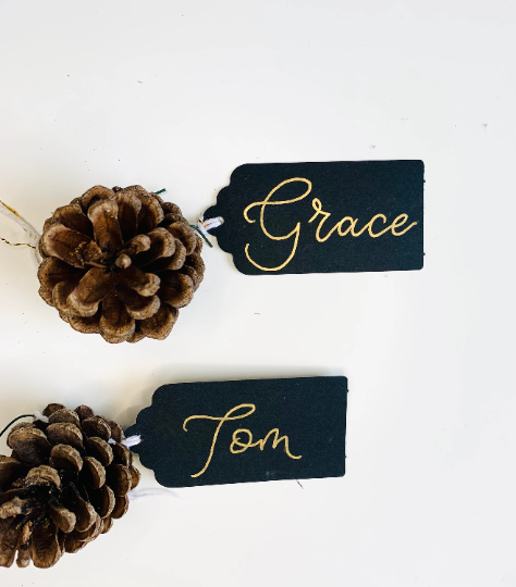 Personalised black gift tags with gold writing in calligraphy