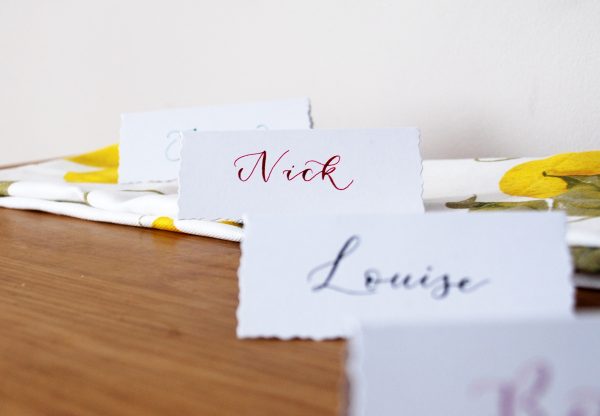 Hand written table setting for wedding with names in calligraphy