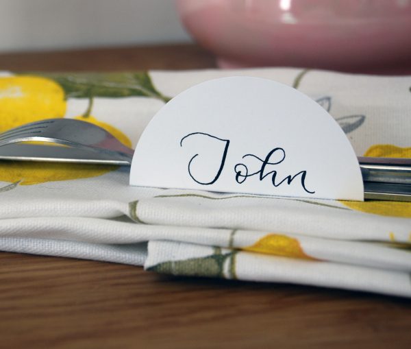 Close up of semi-circle place setting on napkin for event or wedding