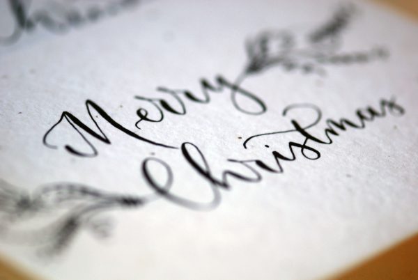 Close up of plantable christmas card that says Merry Christmas in Calligraphy